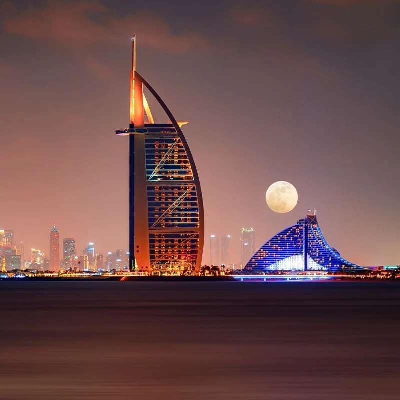 1692970164 night view of dubai hotel zone with close up shot of the moon dubai united arab emirates.jpg