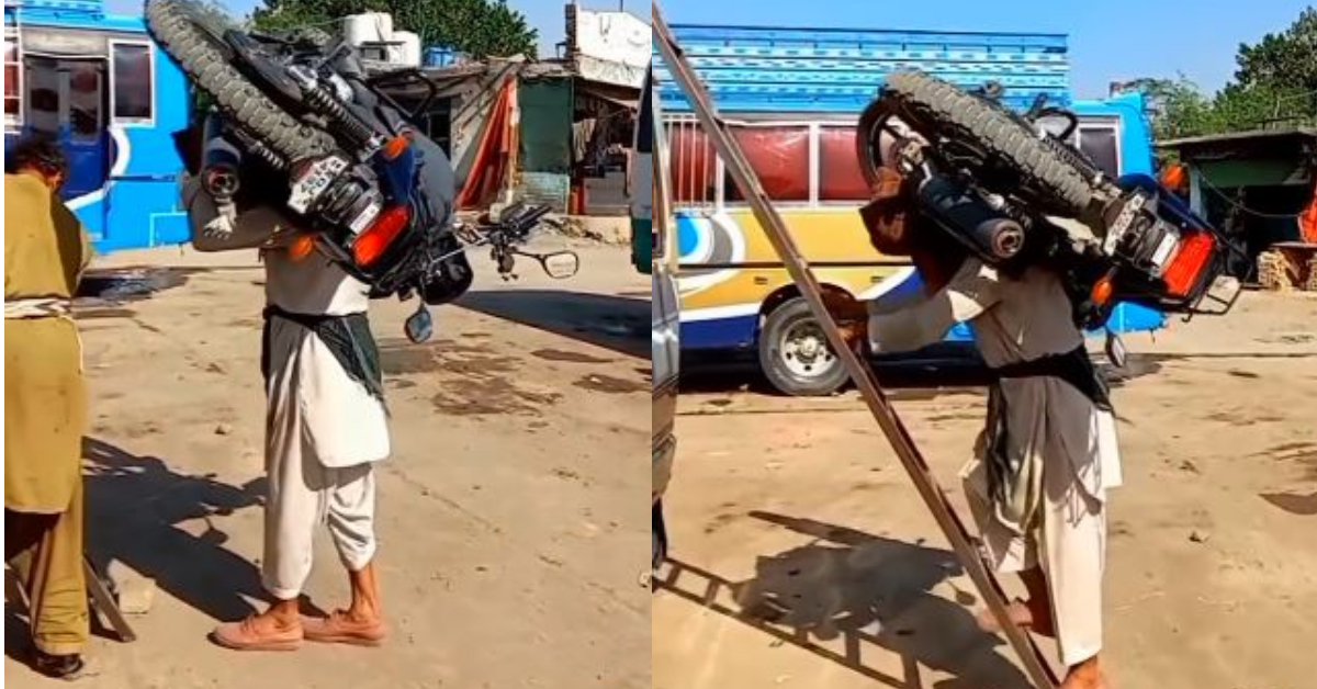 Old Man Lifting Heavy Bike On His Back: